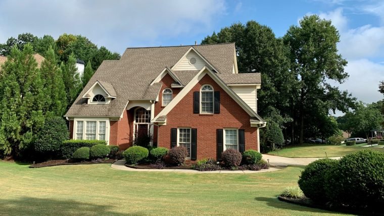 Brick two-storey home with a replaced shingle roof